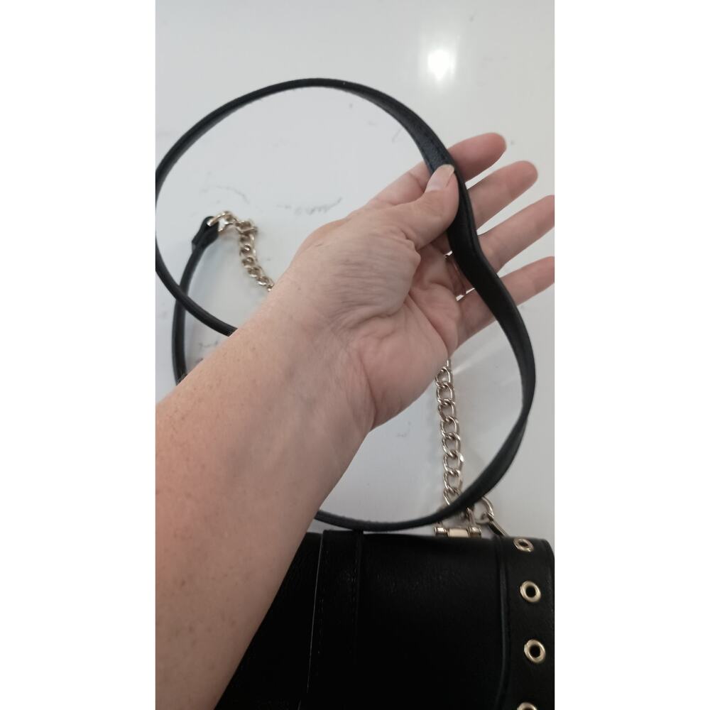 The Express Black Crossbody embellished with Bow metal grommets flap  closure. - Picture 5 of 12